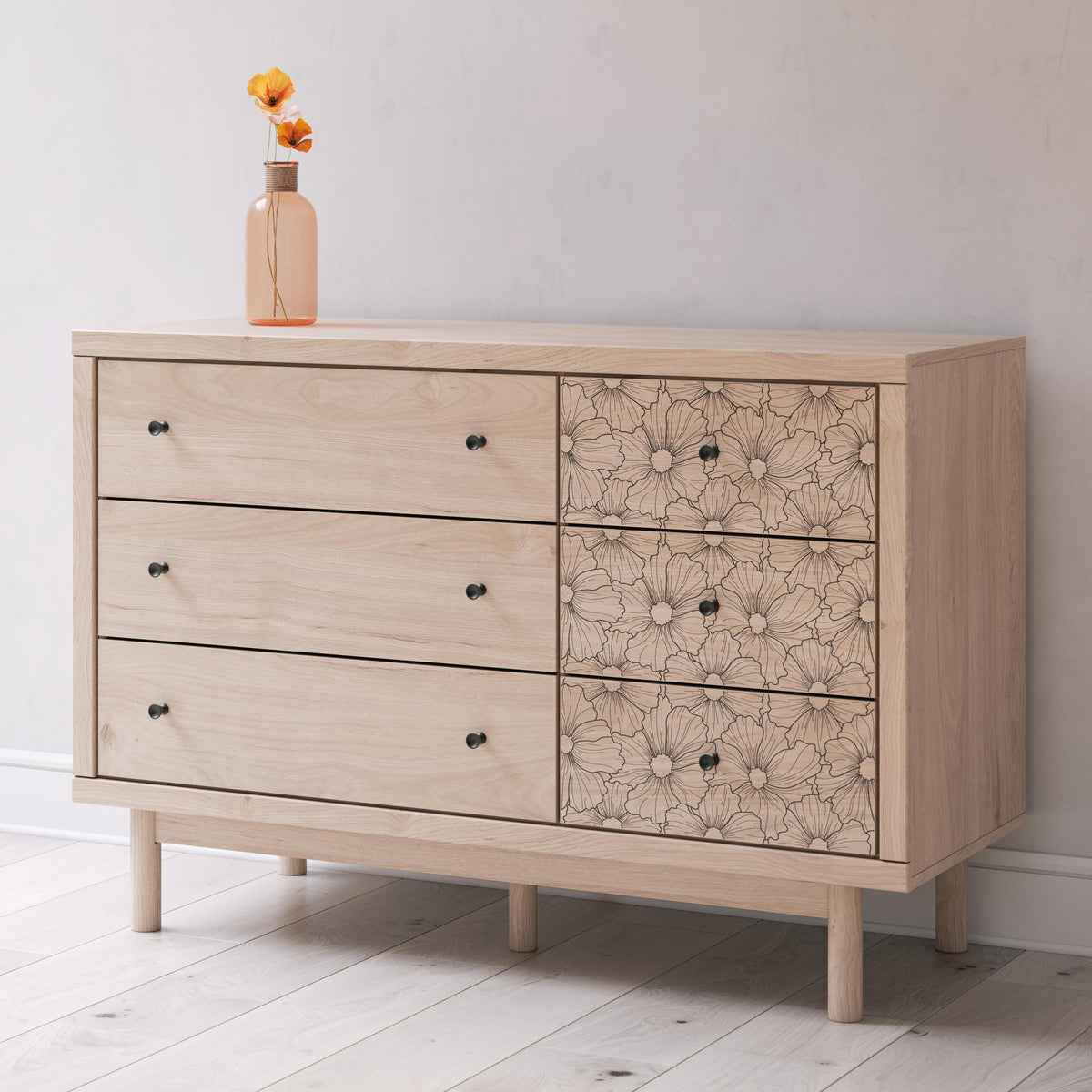 Wooden dresser with floral patterned doors in a minimalistic room.