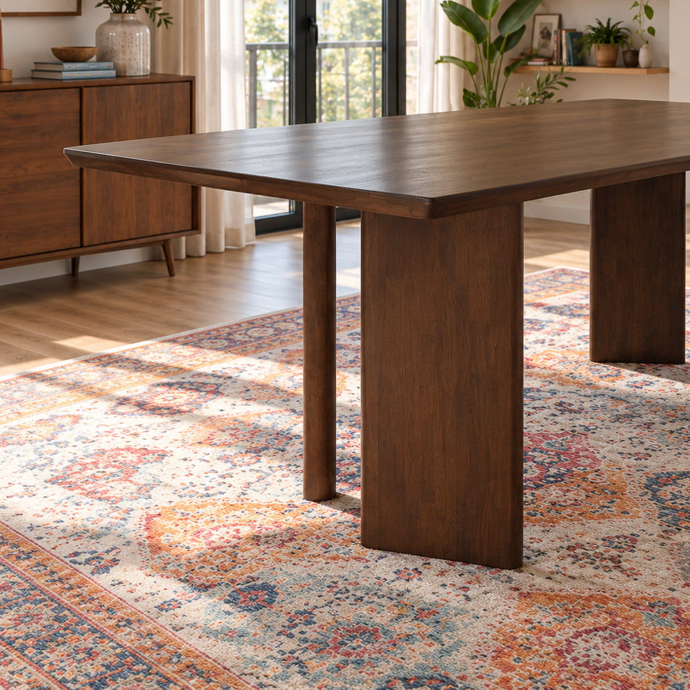 Walnut-toned rectangular dining table with flat panel legs, close up detail view.