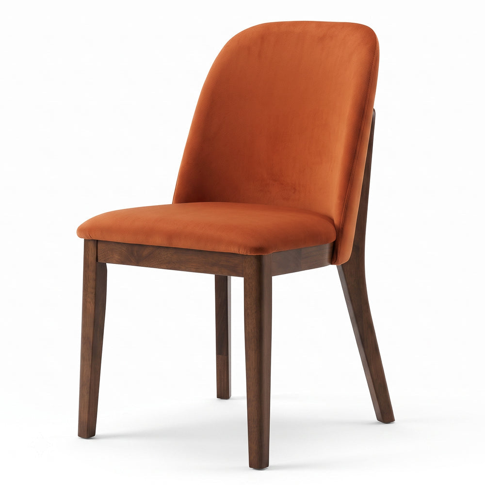 Angled studio view of the velvet dining chair with dark wood legs on a white background