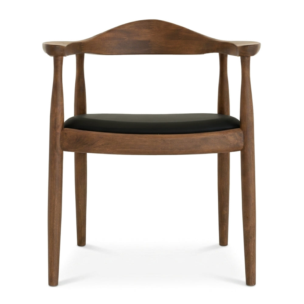 Front-on studio view of the Freya chair showing the curved walnut backrest and black vegan leather seat