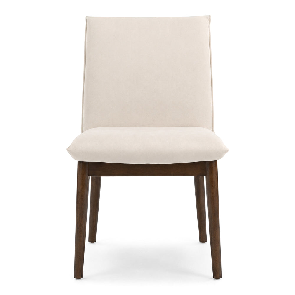 Straight-on front view of a beige velvet dining chair with four splayed wooden legs, on white