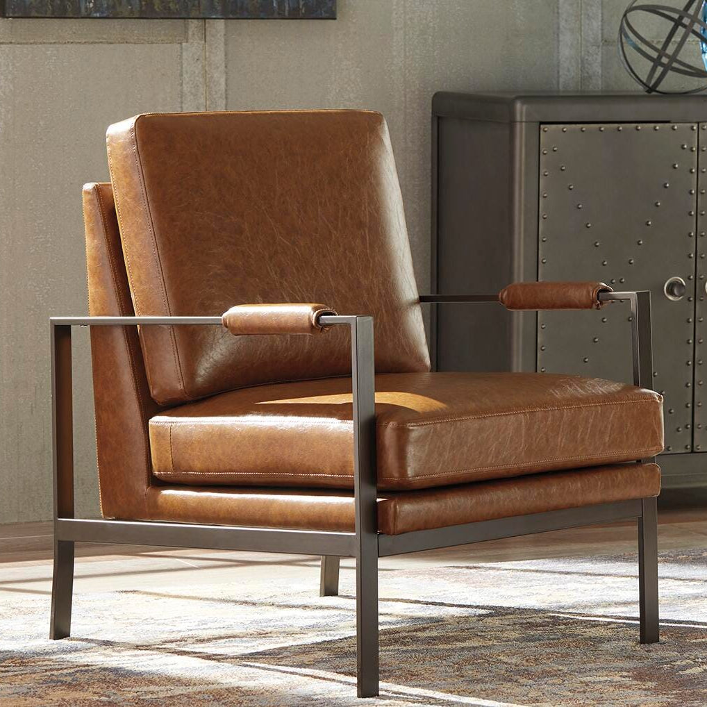 Brown leather armchair with metal frame in a room setting