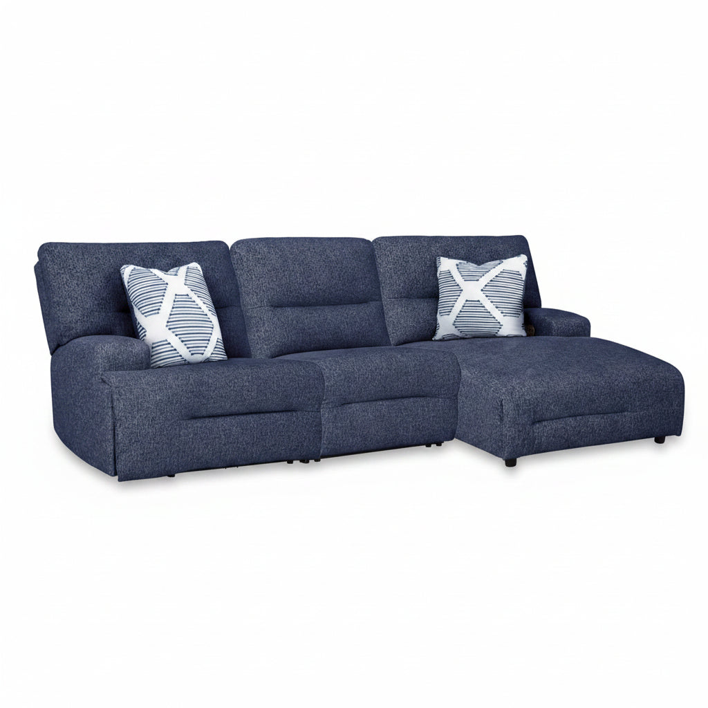Blue sectional sofa with patterned cushions on a white background