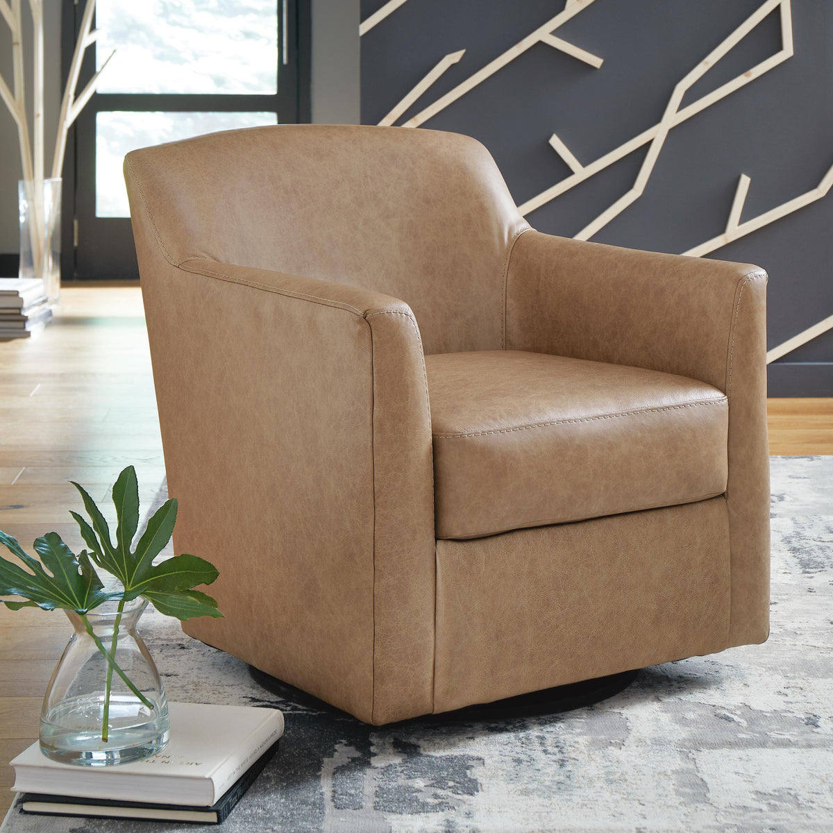 Brown armchair in a room with a decorative wall and a plant on a table.