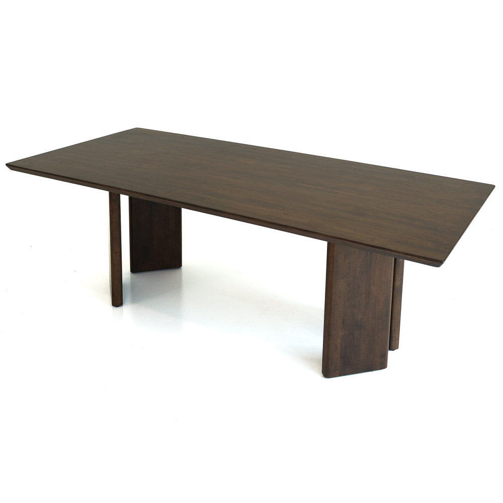 Walnut-toned rectangular dining table with flat panel legs, angled studio view on a plain white background
