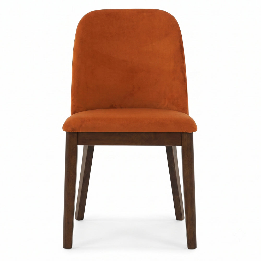 Straight-on front view of the burnt orange velvet dining chair with tapered wood legs