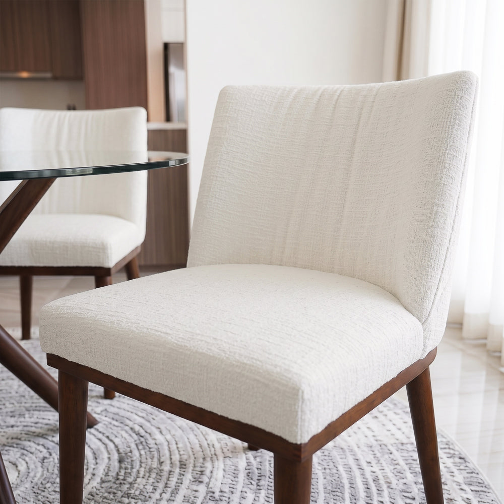 Close-up of the padded seat and curved back, with a second dining chair behind