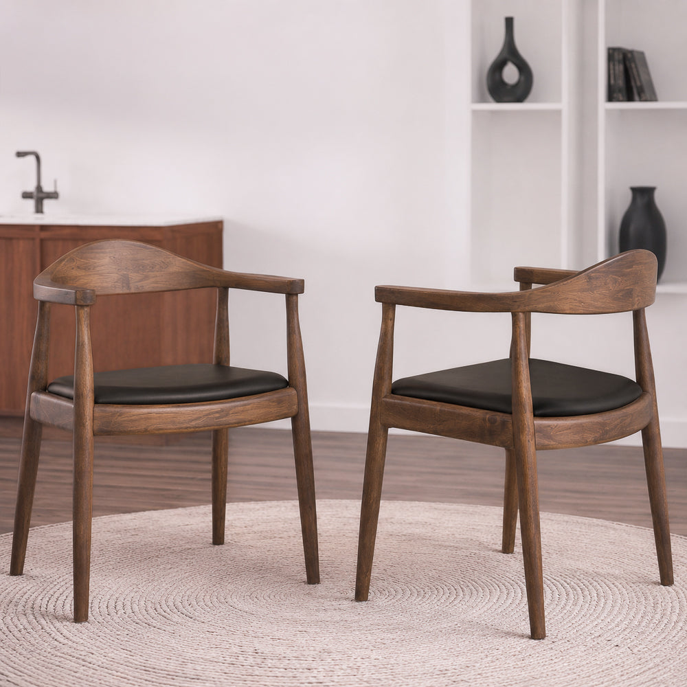 Two Freya chairs on a round jute rug, one front-facing and one angled, with kitchen shelves behind