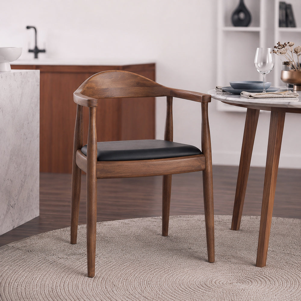 Single Freya chair pulled up to a marble table with a wine glass, plates, and napkin place setting