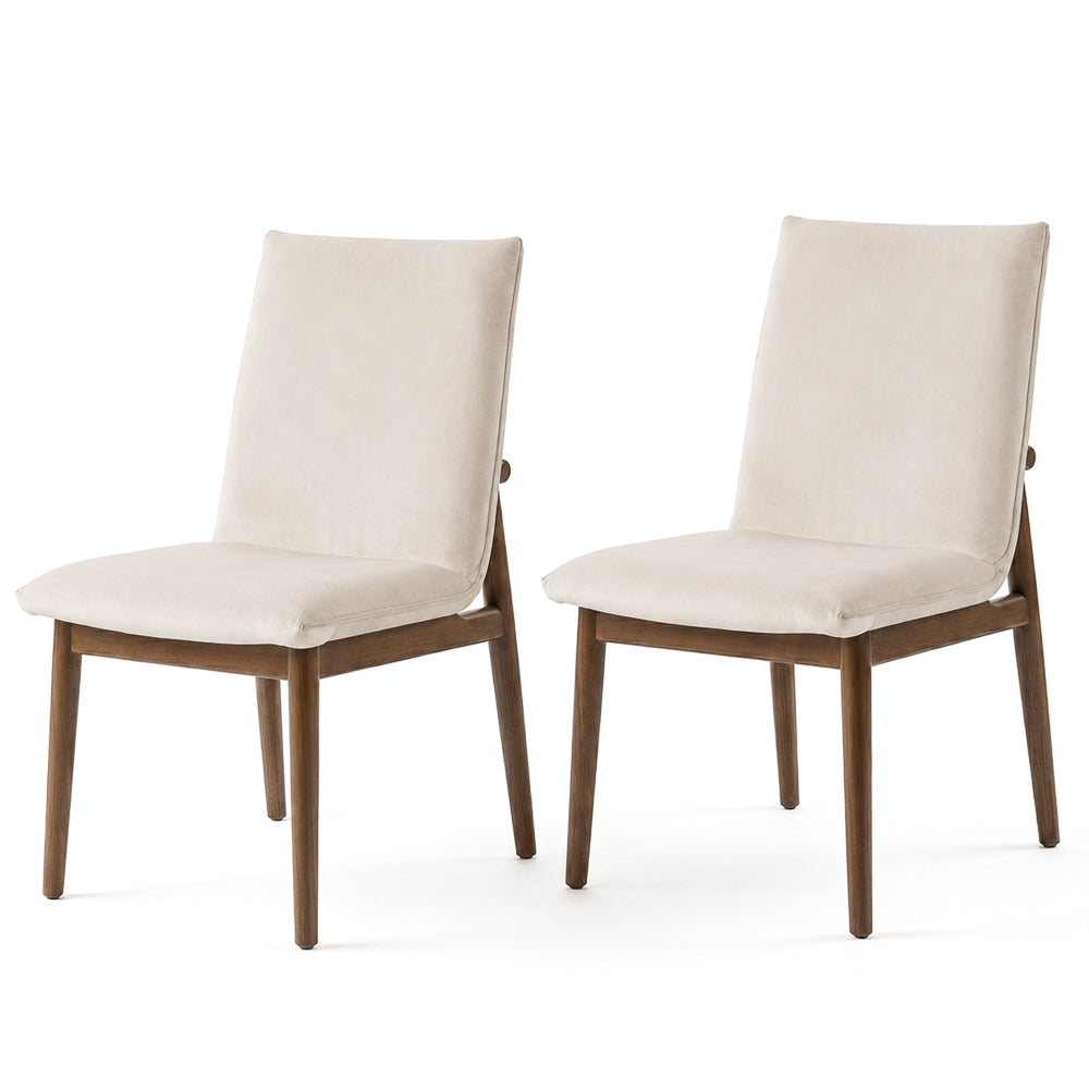Set of 2 beige velvet dining chairs side by side on a white background