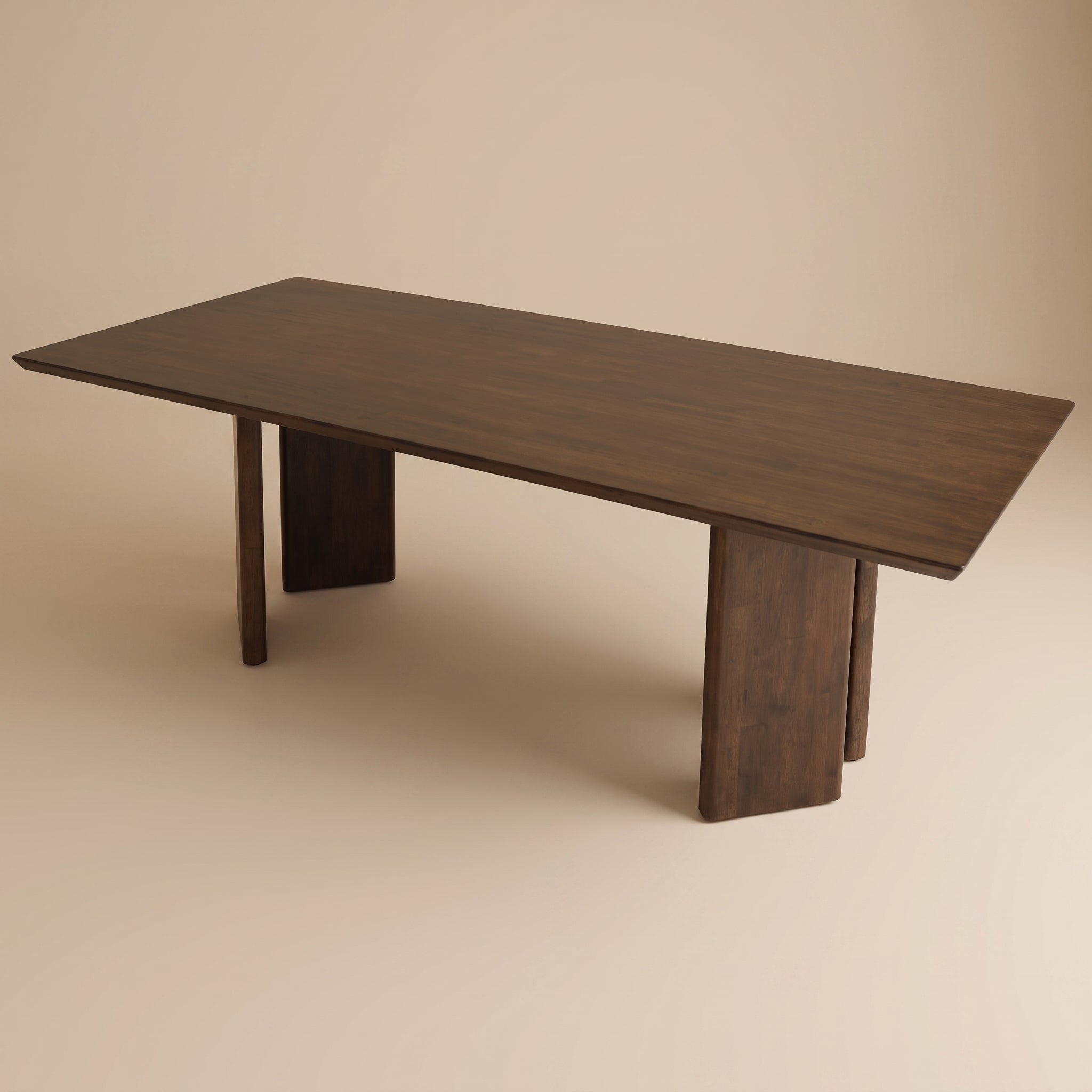 Premium dark wood rectangular dining table with contemporary wide panel legs in a soft beige studio setting.