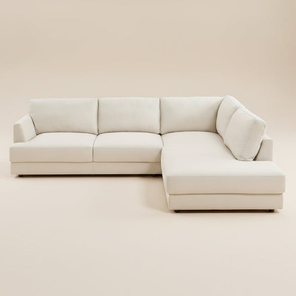 Cream leather right sectional sofa shown front-on against a beige studio backdrop