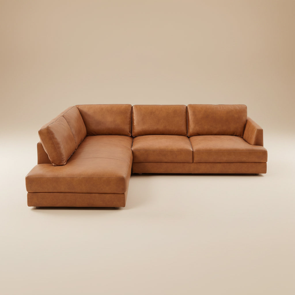 Tan leather left-facing sectional sofa shown straight on against a plain beige studio backdrop